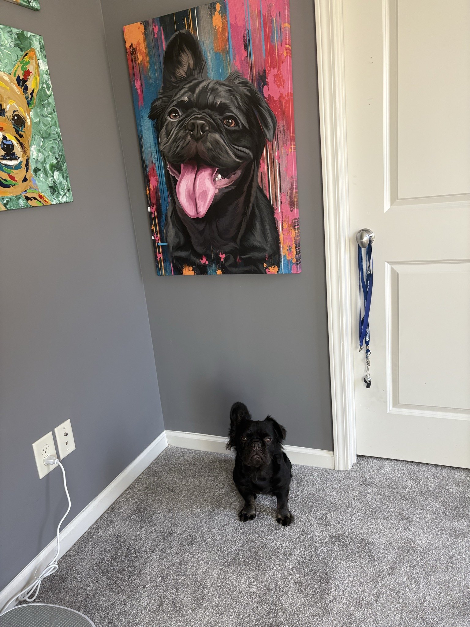 Rosie sitting under a painted portrait of herself
